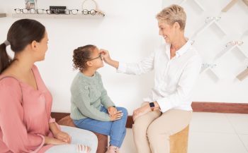Mother, child and happy optometrist with glasses at after examine, eye test or consulting for healt.