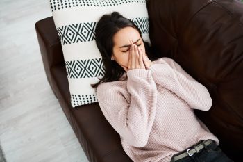 Shot of a young woman experiencing mental anguish at home.