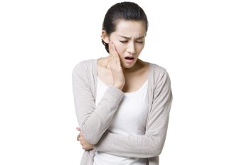 Young Chinese woman with toothache